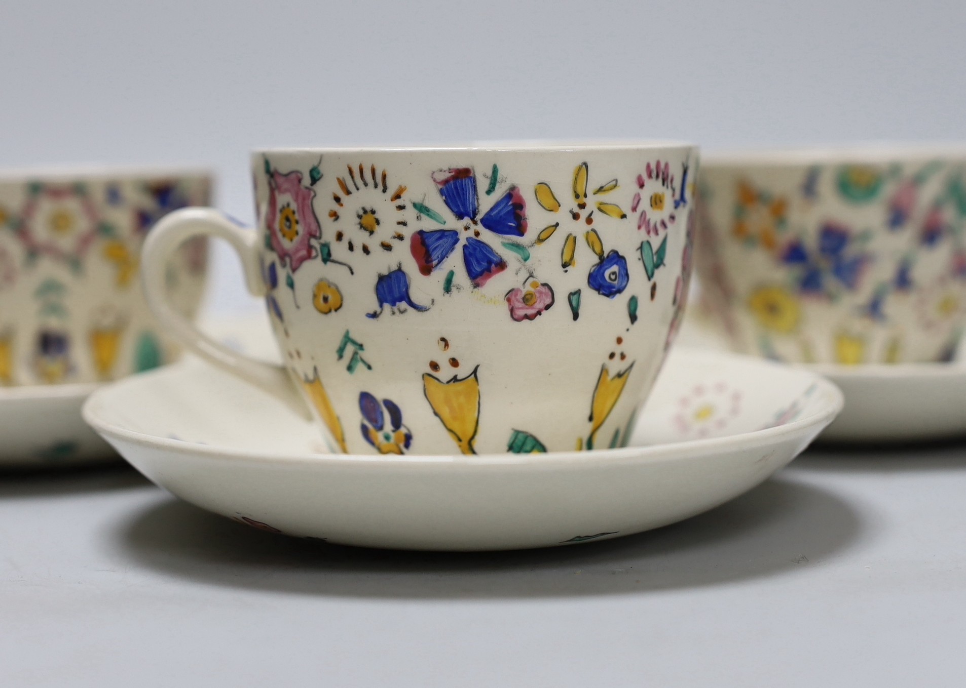 Jessie Marion King. A set of six floral teacups and saucers
